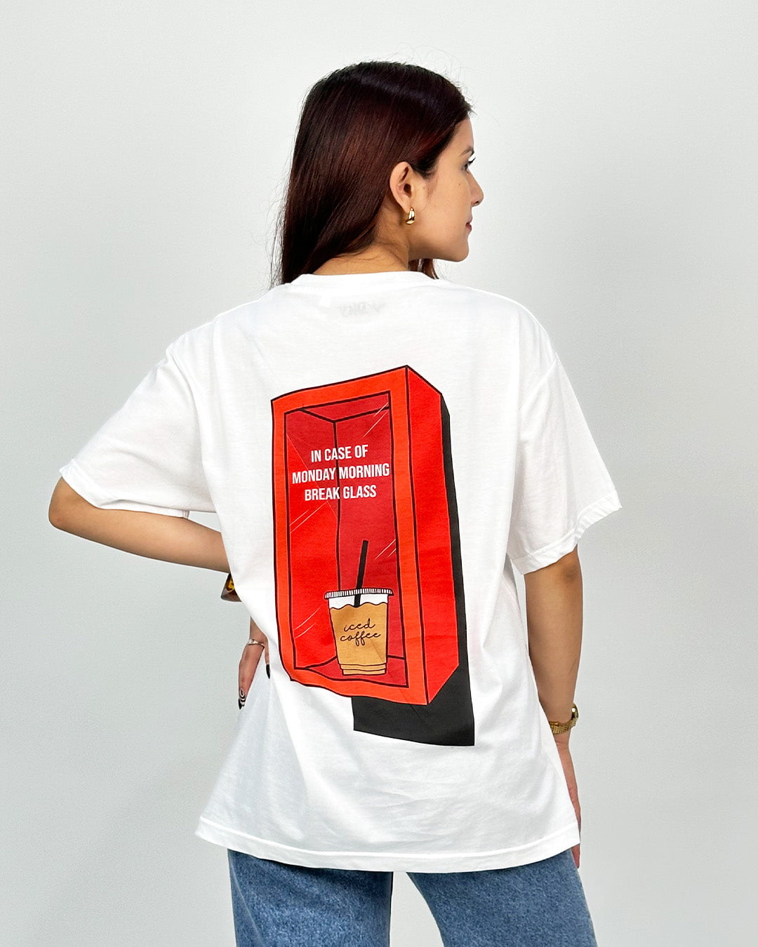 Break Glass Oversized T-Shirt – white graphic tee with a red back print of a coffee cup in a red frame, worn by model