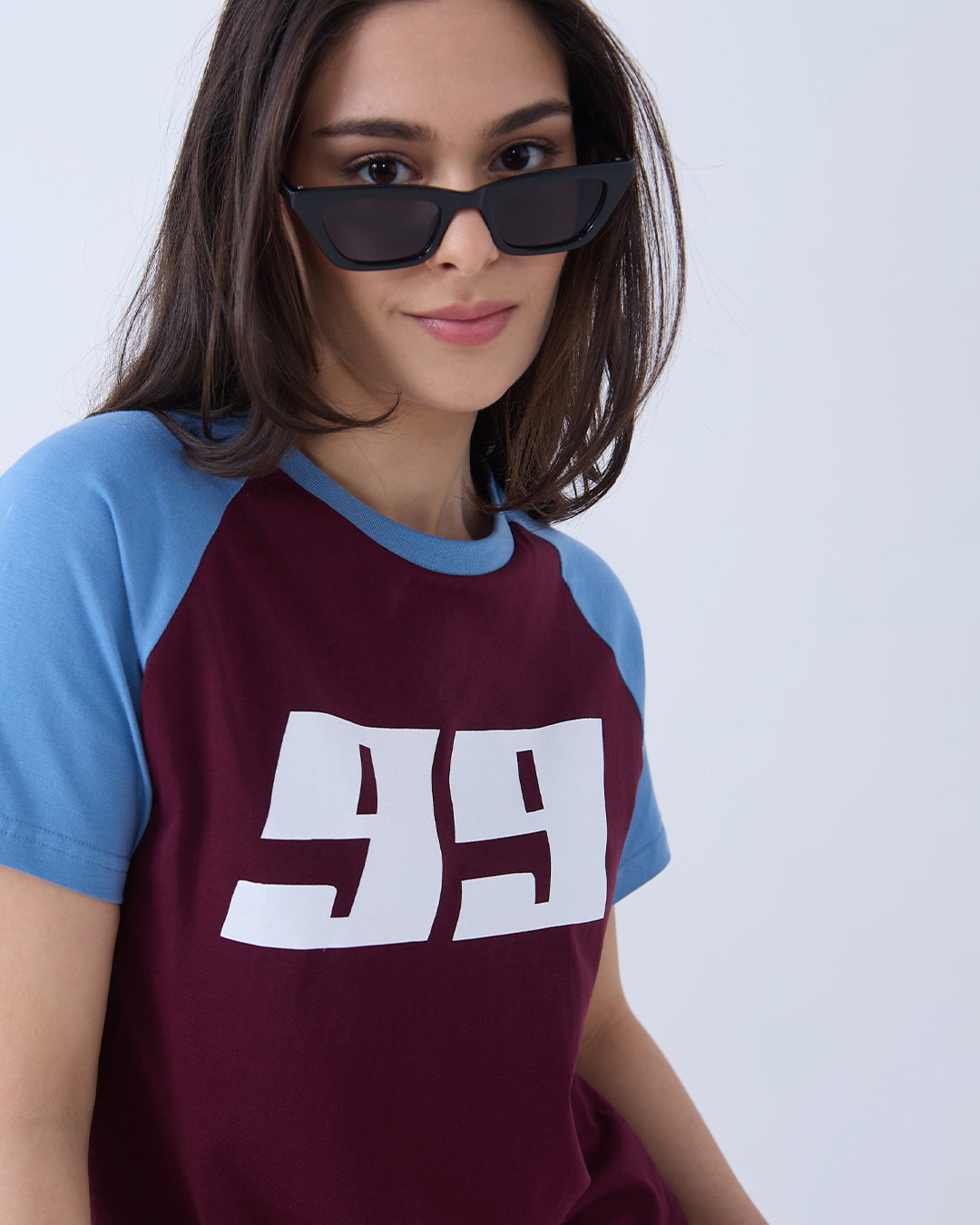 Maroon 99 Raglan T-Shirt – maroon body with blue raglan sleeves and white 99 graphic, worn by model