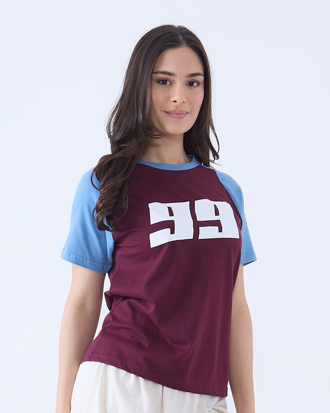 Maroon 99 Raglan T-Shirt - maroon body with light blue sleeves and a white 99 graphic on the chest, worn by model.