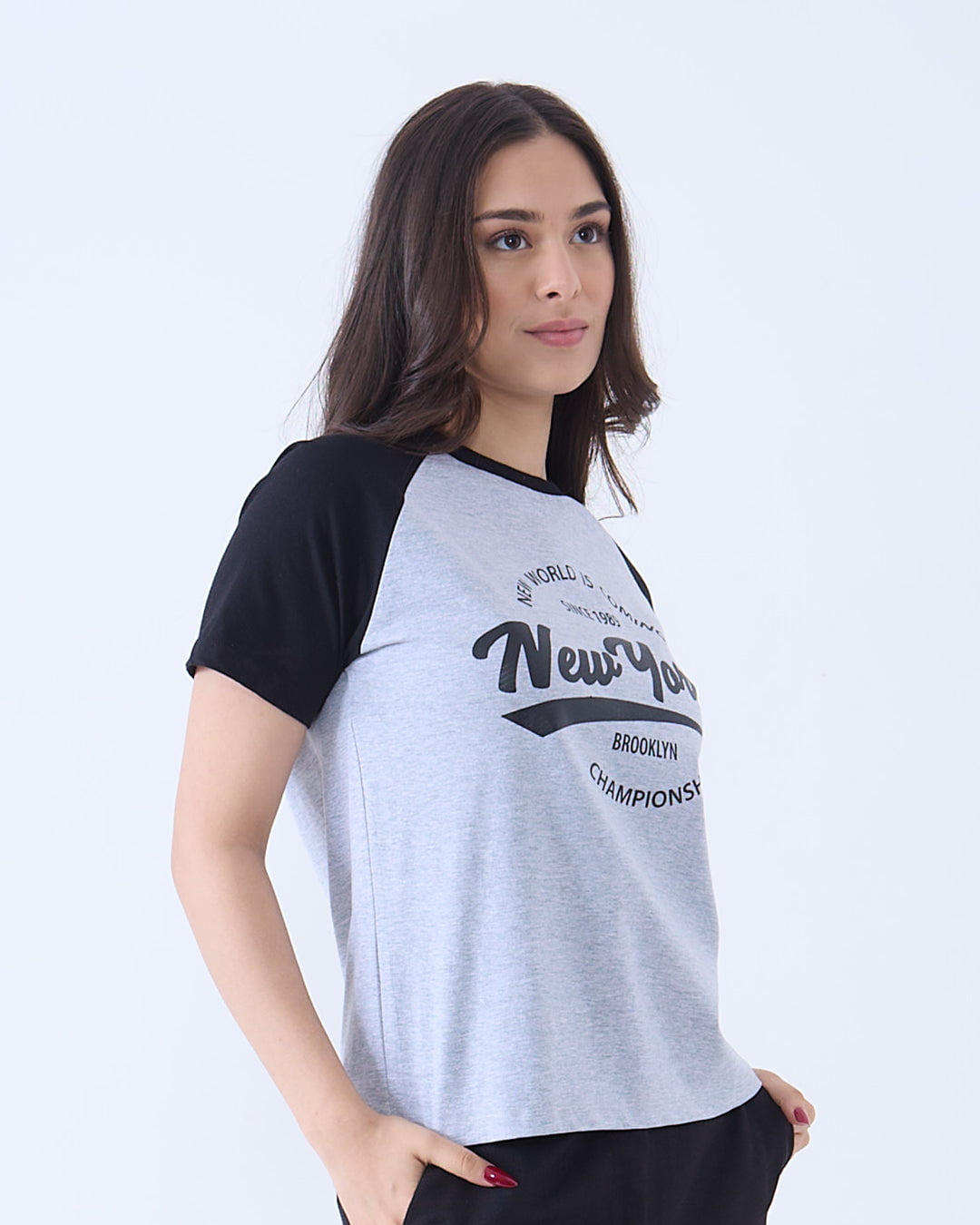 Grey New York Raglan T-Shirt grey body with black raglan sleeves and front New York graphic, worn by model
