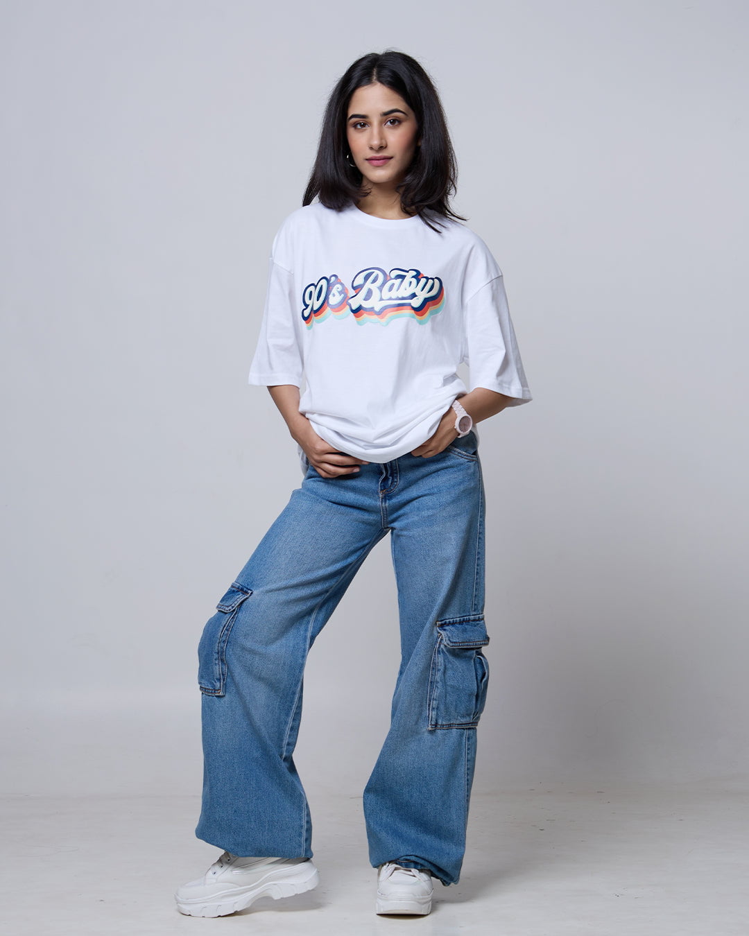 Retro Baby Oversized T-Shirt – white, oversized graphic tee with a colorful retro rainbow print, worn by model