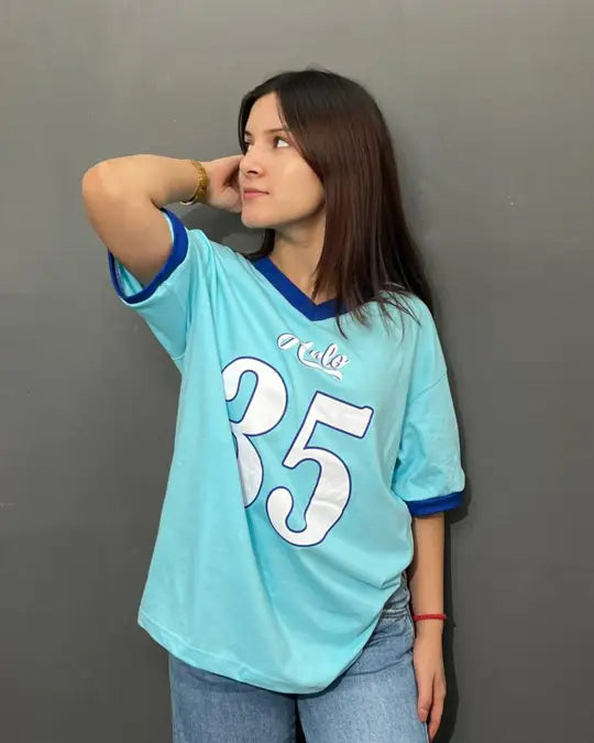 35 Tap-Out V-Neck Oversize T-Shirt – light blue oversized DKY tee with bold white 35 graphic, worn by model