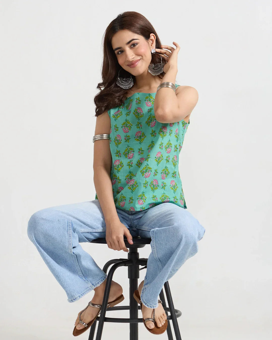 Floral Fix Short Cotton Top ā turquoise green sleeveless printed top with pink floral print, worn by model