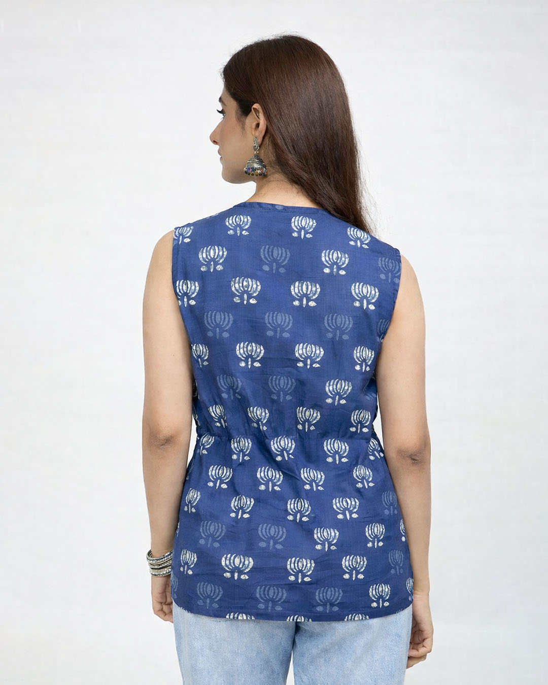 Blue Inayat Cinched Top ā blue sleeveless printed top with white floral motif, cinched waist, worn by model