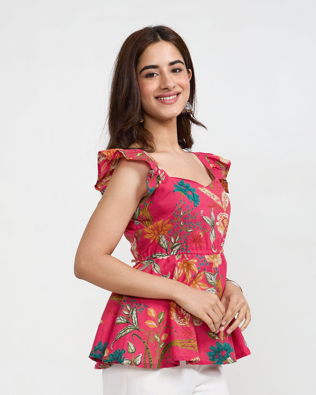 Pink Ella Ruffle Top – floral print with ruffled sleeves, worn by model