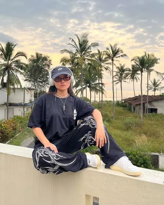 Arlo Black Gangster Oversized T-Shirt โ black oversized tee with a relaxed fit, worn by model outdoors among palm trees