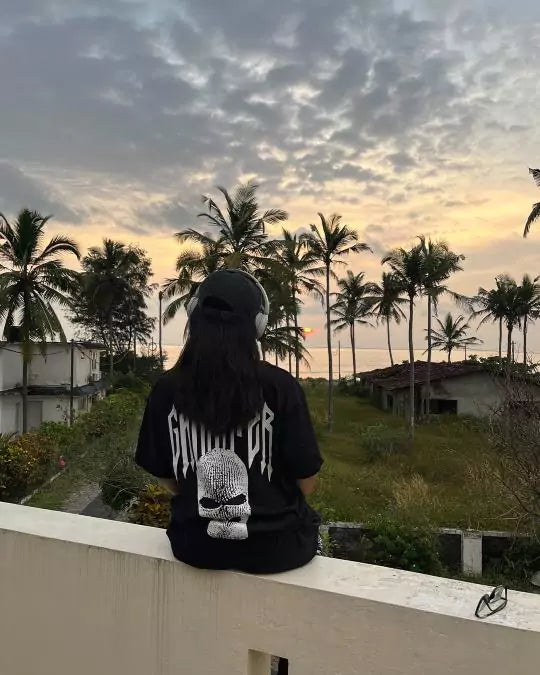 Arlo Black Gangster Oversized T-Shirt โ black 100% cotton tee with back skull graphic, worn by person