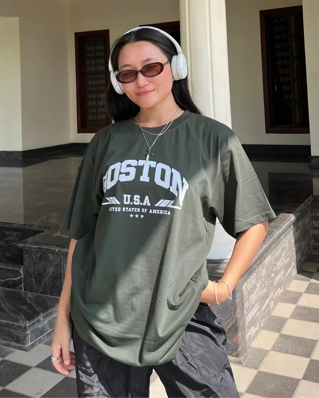 Arlo Boston Oversized T-Shirt โ olive green oversized tee with Boston U.S.A graphic, worn by model.