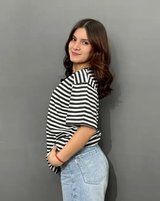 B&W Strip T-Shirt ā black and white striped relaxed-fit tee from DKY worn by model in blue jeans