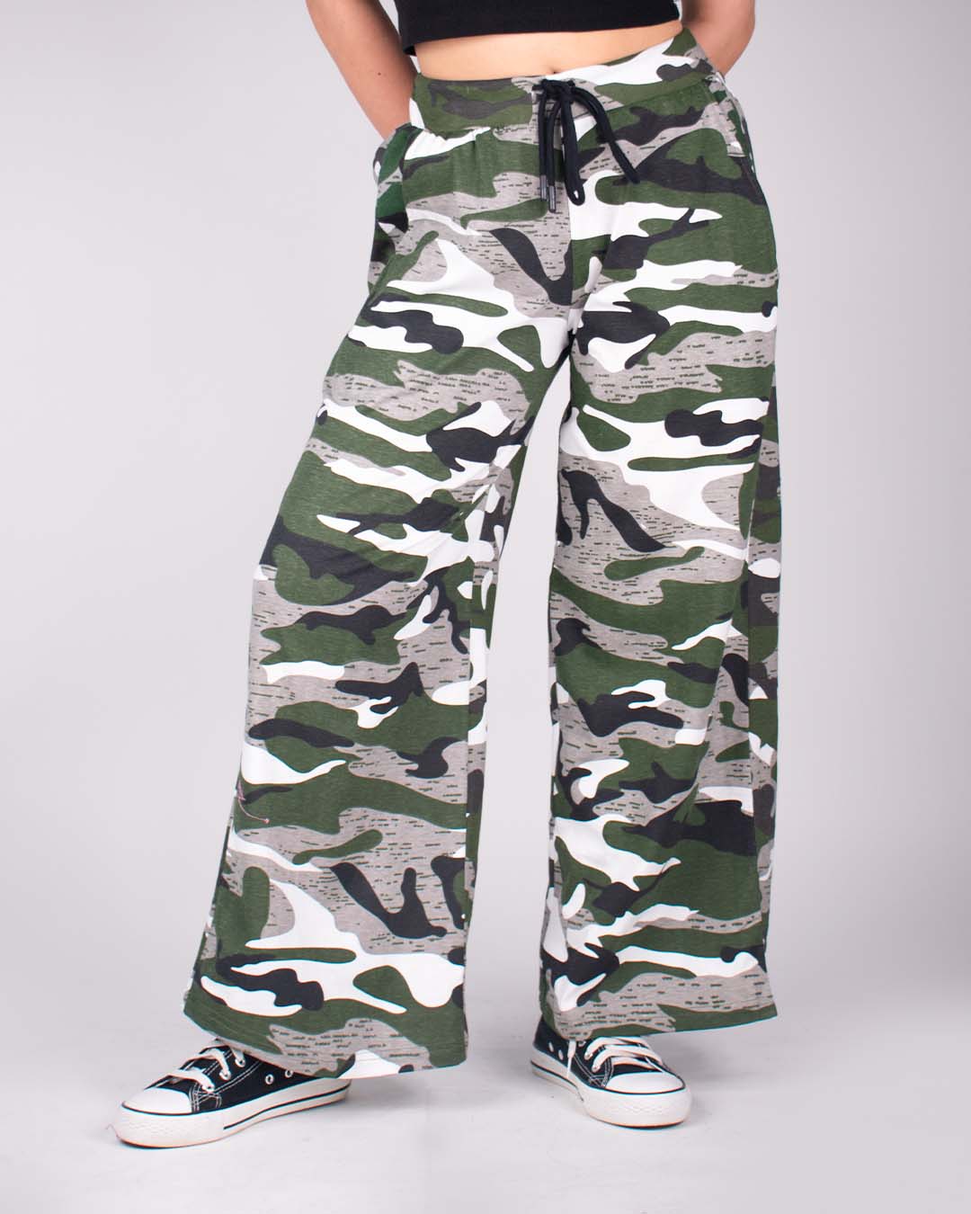 Camo Pajama pants – camouflage green, black, and beige wide-leg pants with a drawstring, worn by model