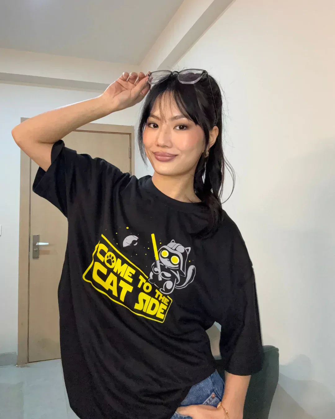 Cat Side Oversized T-shirt – black graphic tee with a yellow Come to the Cat Side cat design, worn by model
