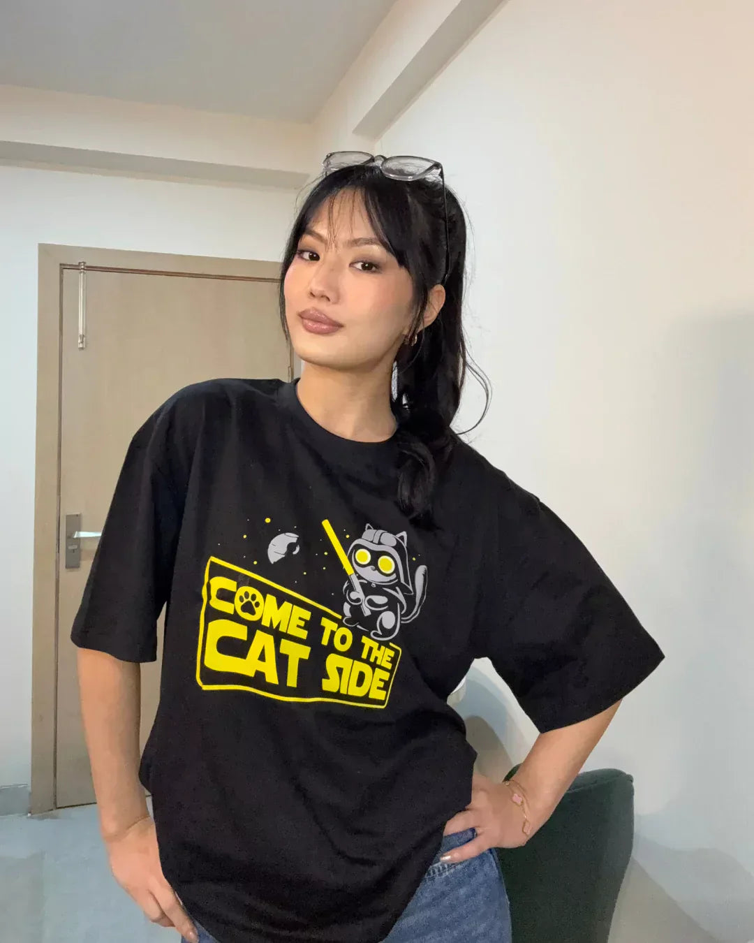 Cat Side Oversized T-shirt - black DKY graphic tee with yellow cat design and Come to the Cat Side text, worn by model
