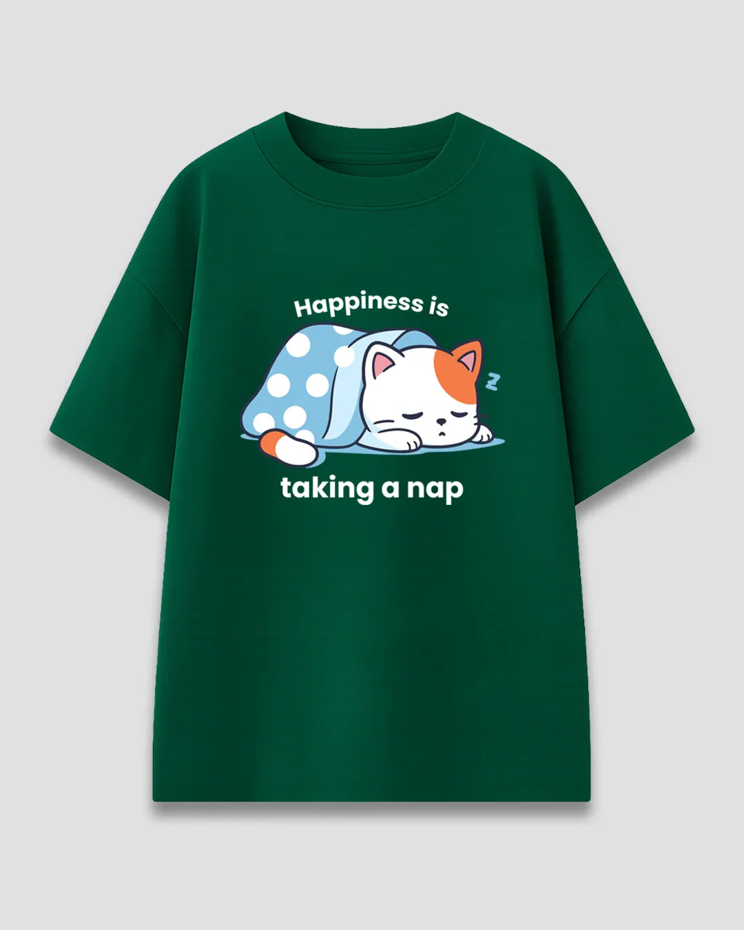 Happy Nap Oversized T-Shirt – green tee with a sleeping cat under blue polka-dot blanket and Happiness is taking a nap