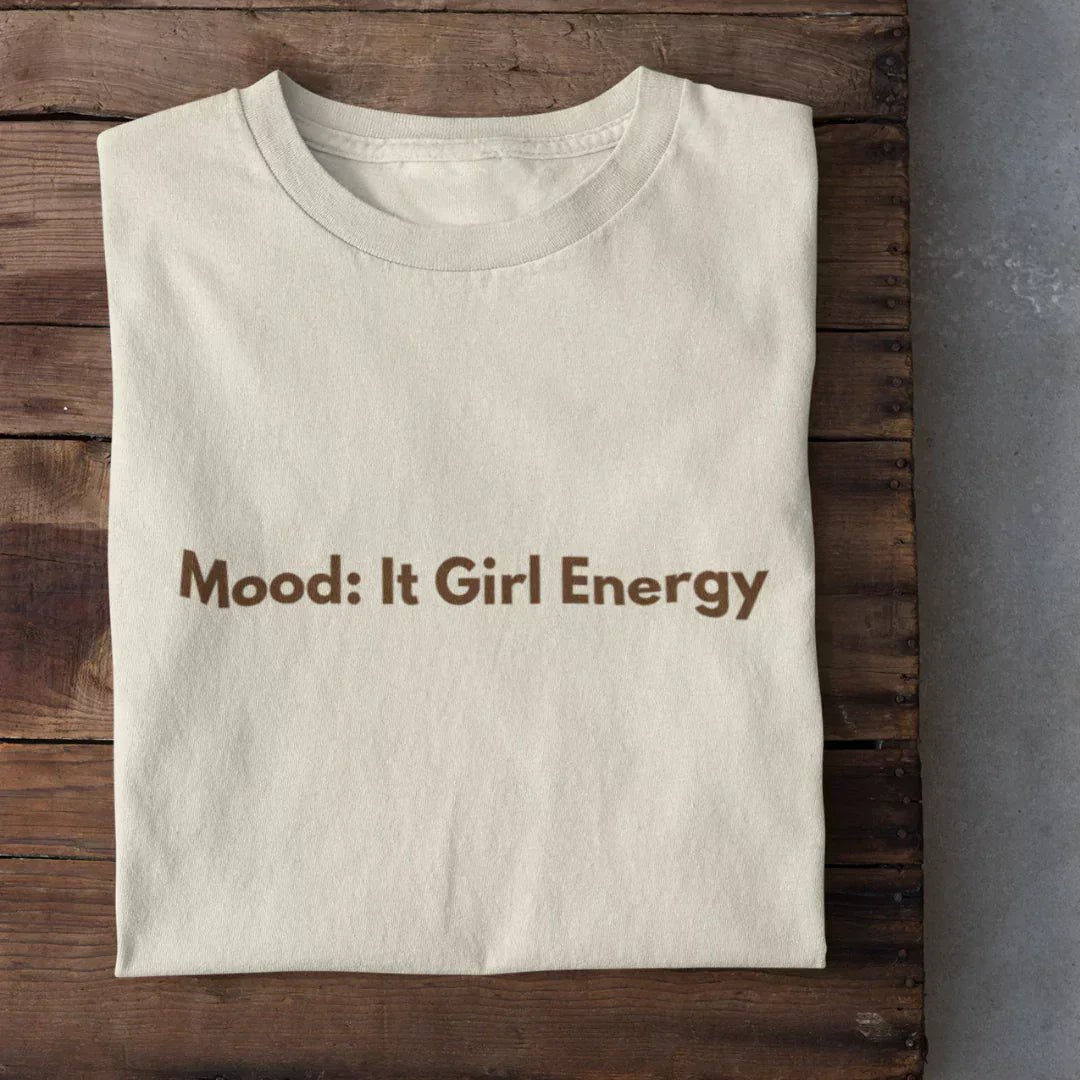 It Girl Energy T-Shirt - cream regular tee with brown Mood: It Girl Energy text, shown in flat lay