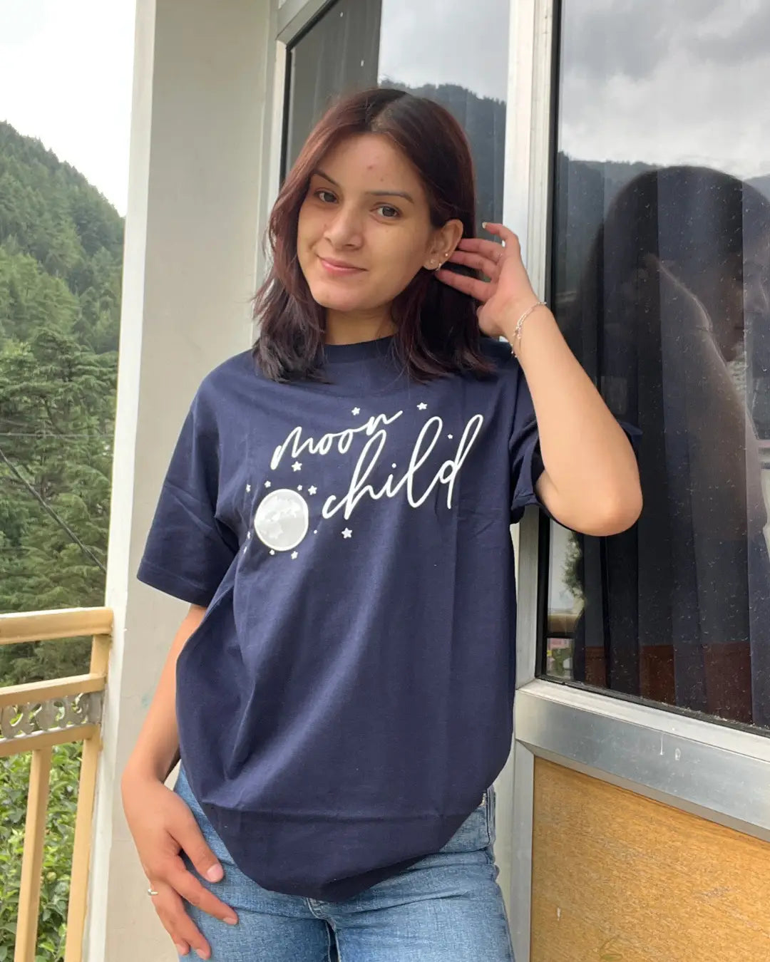 Moon Child T-Shirt - navy blue regular tee with moon and stars graphic, worn by model