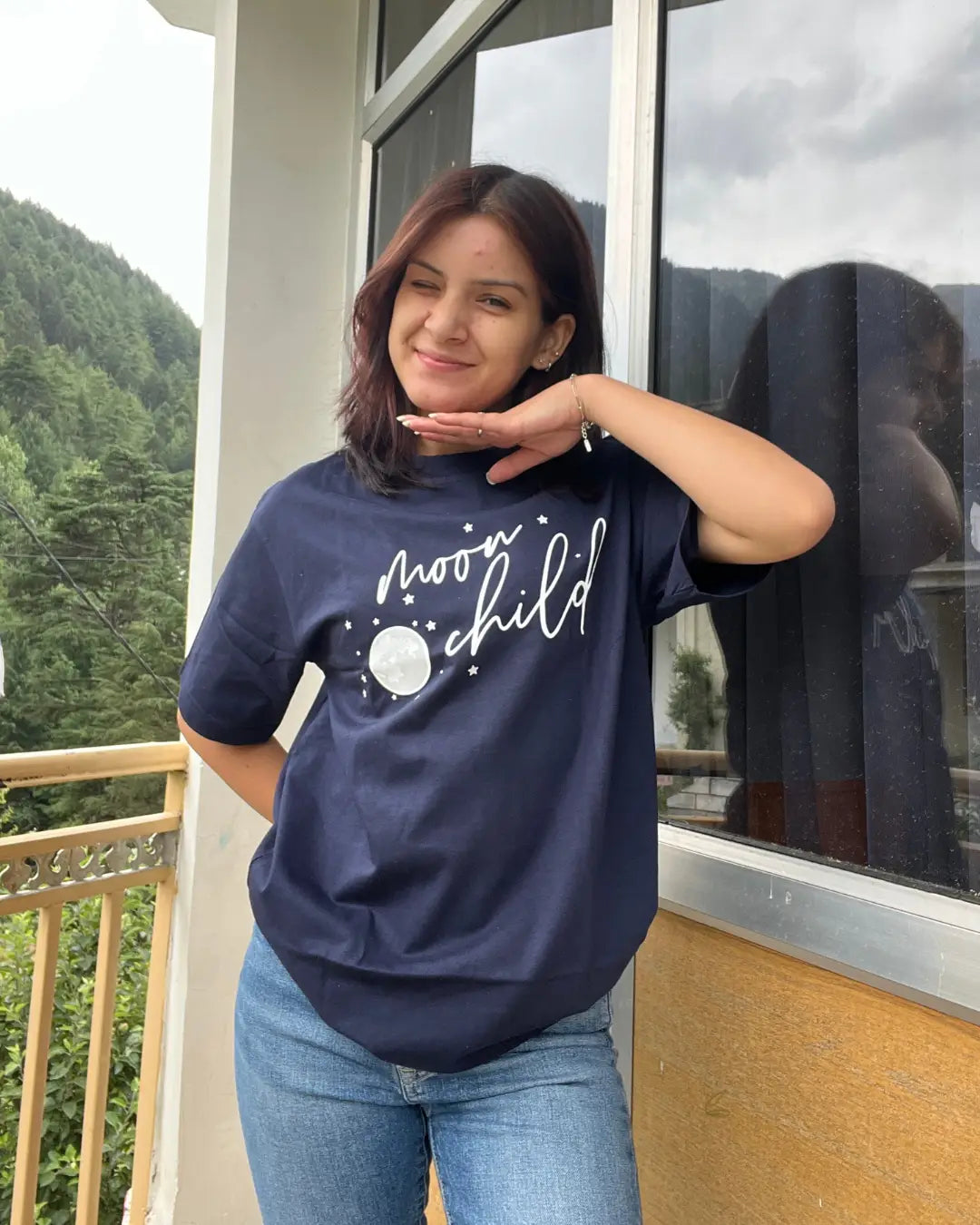 Moon Child T-Shirt – navy blue regular tee with white moon graphic and Moon Child text, worn by model