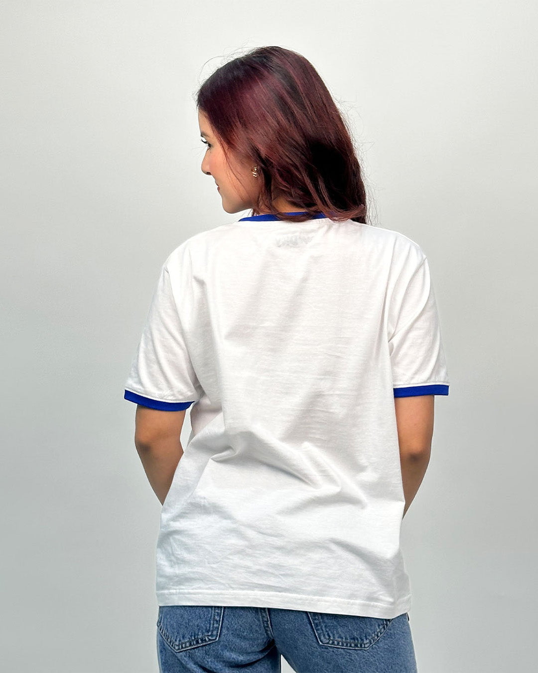 Outer Banks Tap Out T-Shirt - white regular tee with blue collar and sleeve trim, worn by model