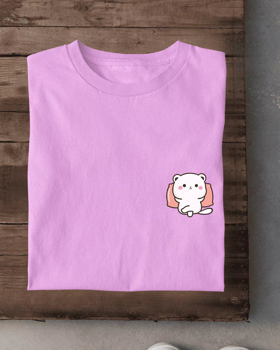 Relax Character T-Shirt – pink DKY regular tee with a small cartoon bear on the pocket, shown in flat lay
