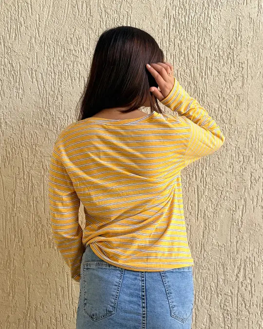 Tan Lines Scoop Neck T-Shirt – yellow and white striped long-sleeve top in a relaxed fit, worn by a model with denim jeans