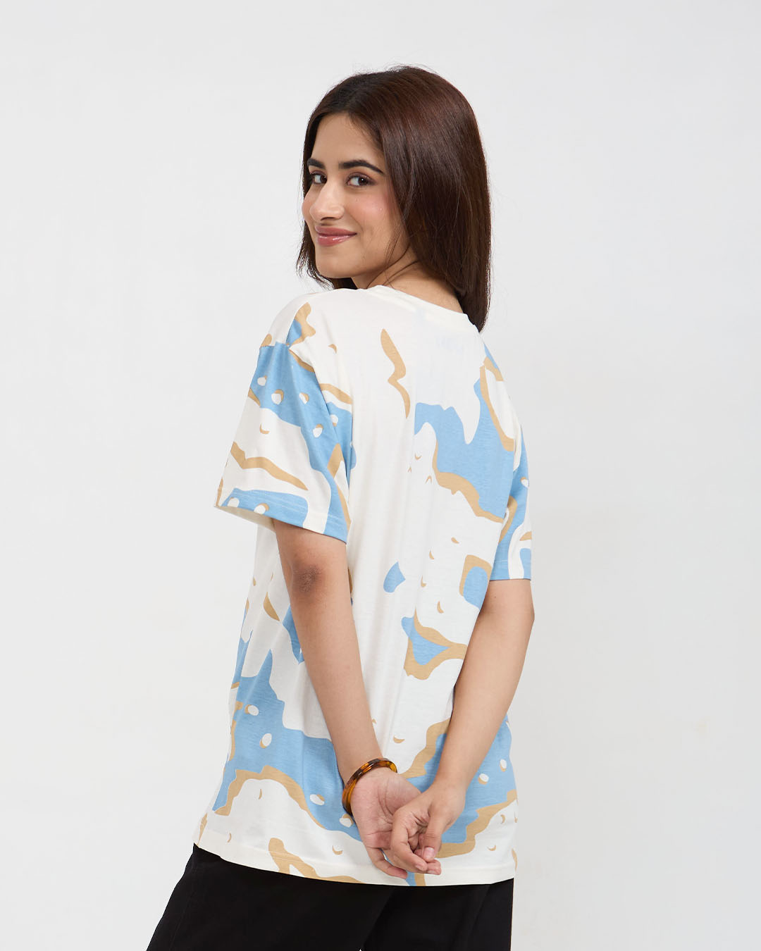 Wavy Oversized T-Shirt – white tee with blue and tan abstract print, worn by model