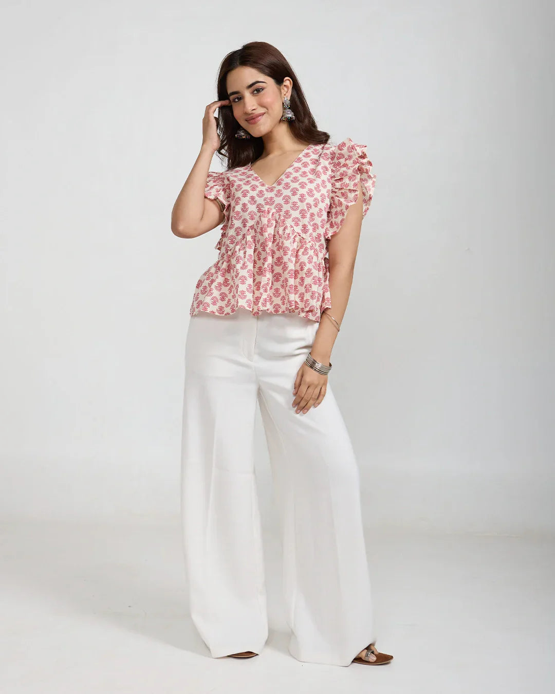 White Cherry Peplum Top with pink cherry print on white, flutter sleeves, peplum fit worn by model