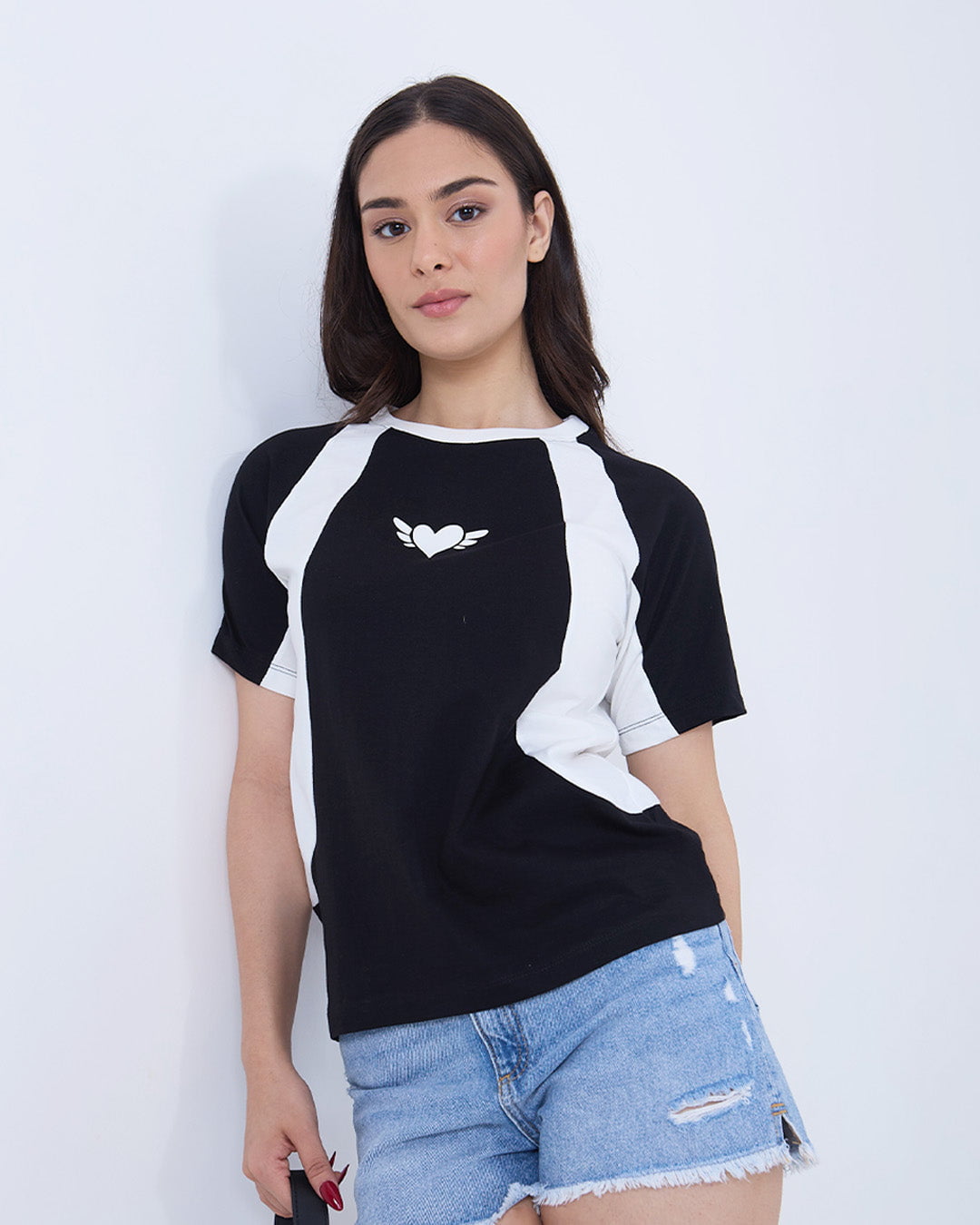 Wings All-Star Oversize T-Shirt - black body with white raglan sleeves and a heart-with-wings logo, worn by model