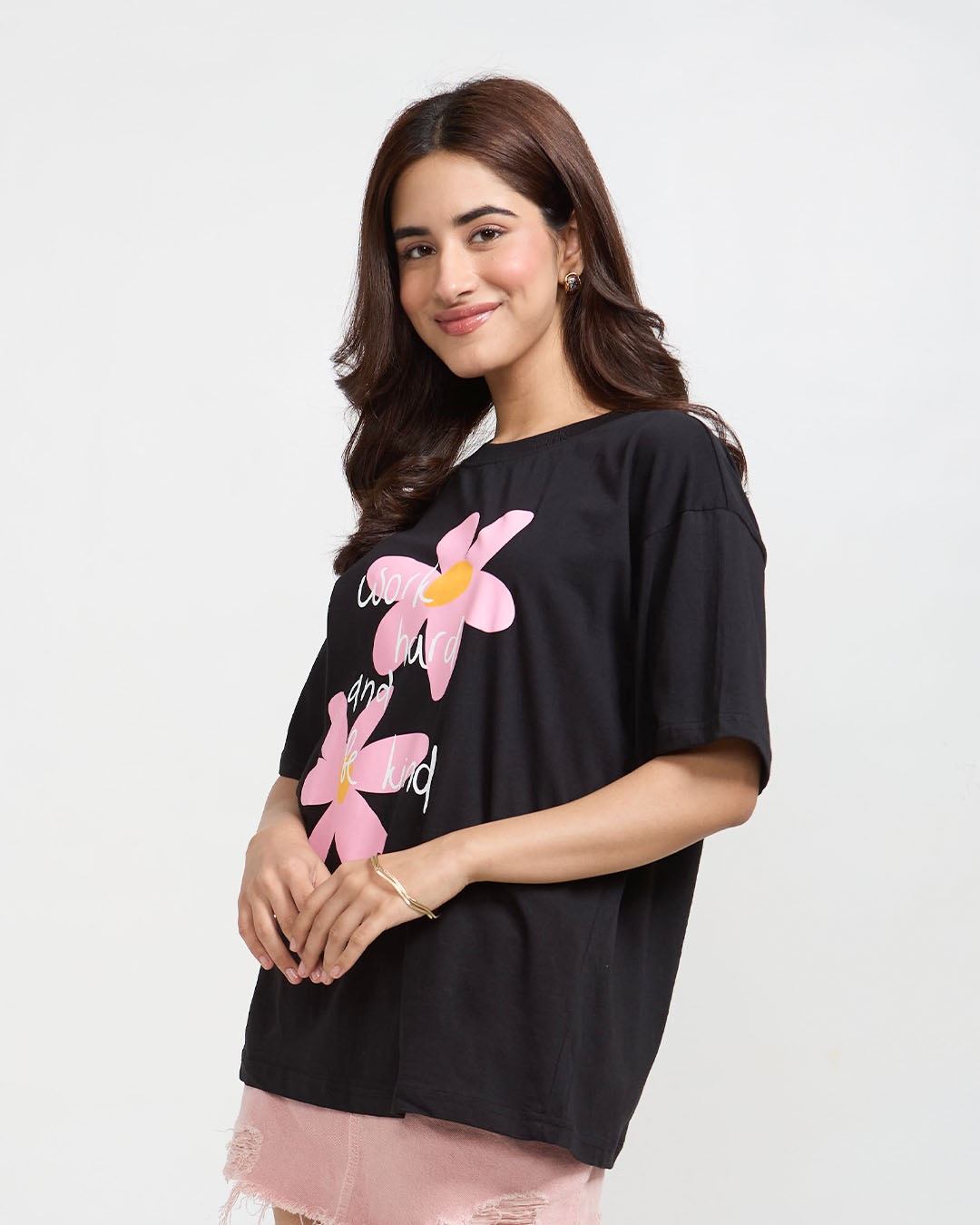 Work Hard And Be Kind Oversized T-Shirt – black graphic tee with pink floral print and white script, worn by model