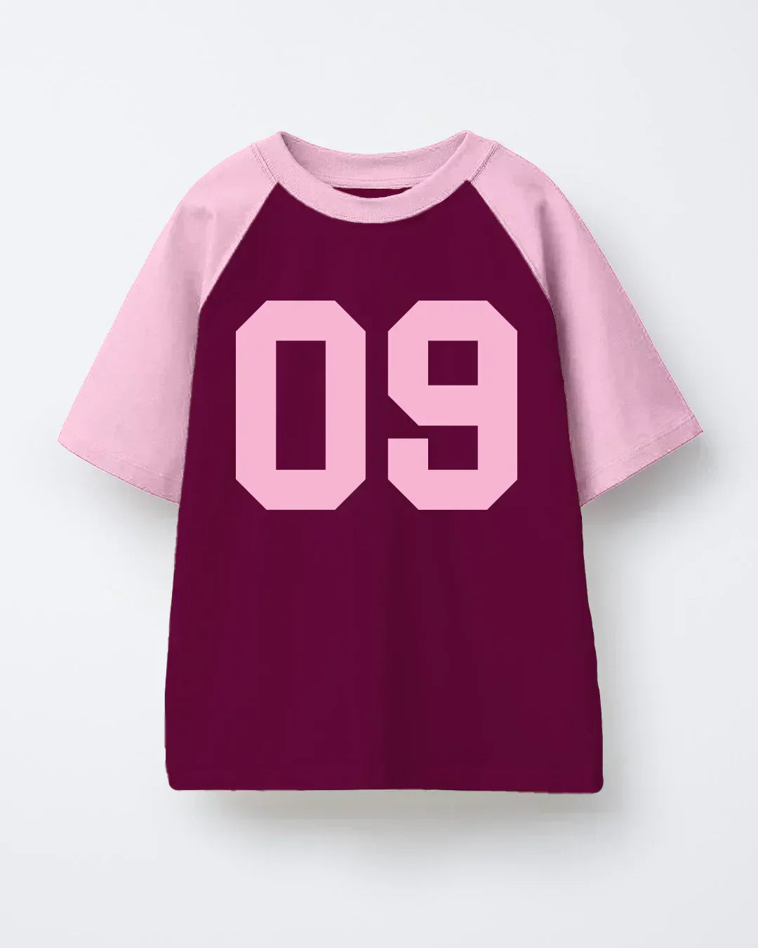 09 Raglan Oversized T-Shirt – maroon body with pink raglan sleeves and large pink 09 numeral, shown in flat lay