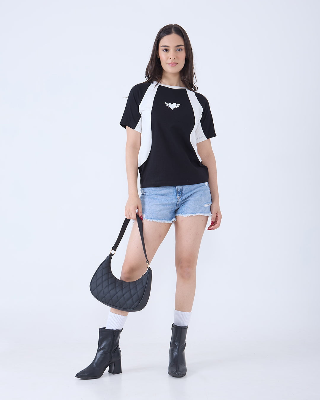 Wings All-Star Oversize T-Shirt – black with white panels, oversized regular tee with heart and wings logo, worn by model