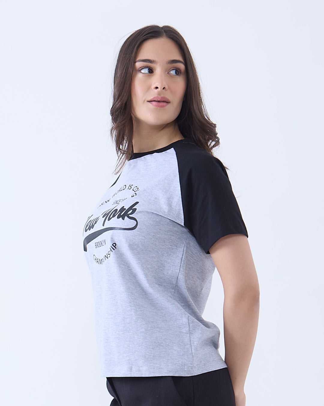 Grey New York Raglan T-Shirt by DKY – heather grey body, black raglan sleeves with a New York graphic, worn by model