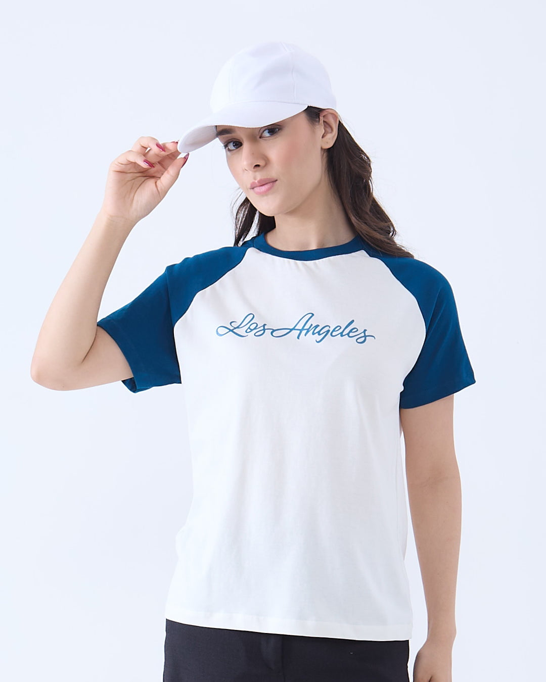 Los Angeles Raglan T-Shirt – white body with blue raglan sleeves and blue script Los Angeles on the chest, worn by model