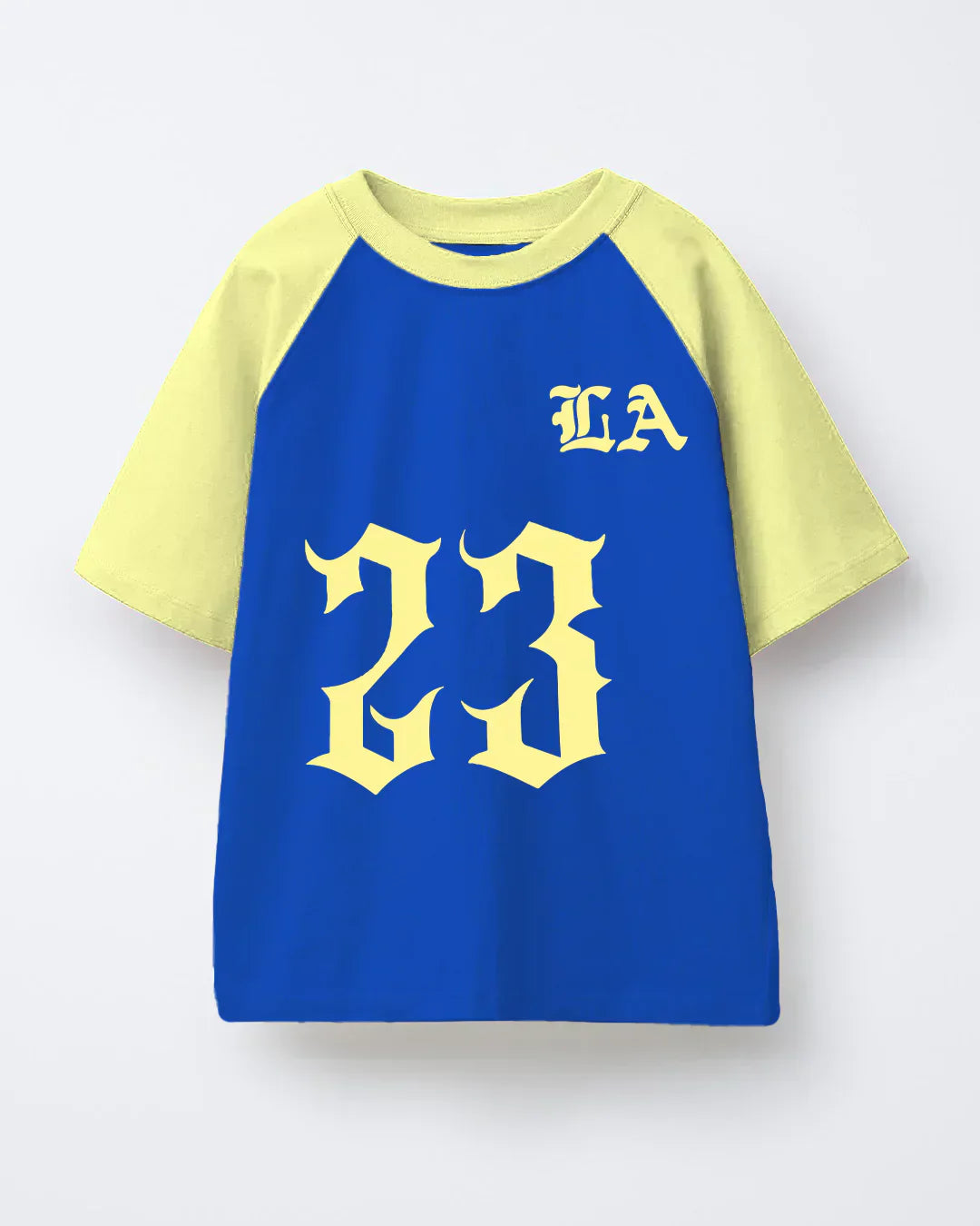 23 LA Raglan Oversized T-Shirt – blue body with pale yellow sleeves, large yellow gothic LA graphic on front, flat lay