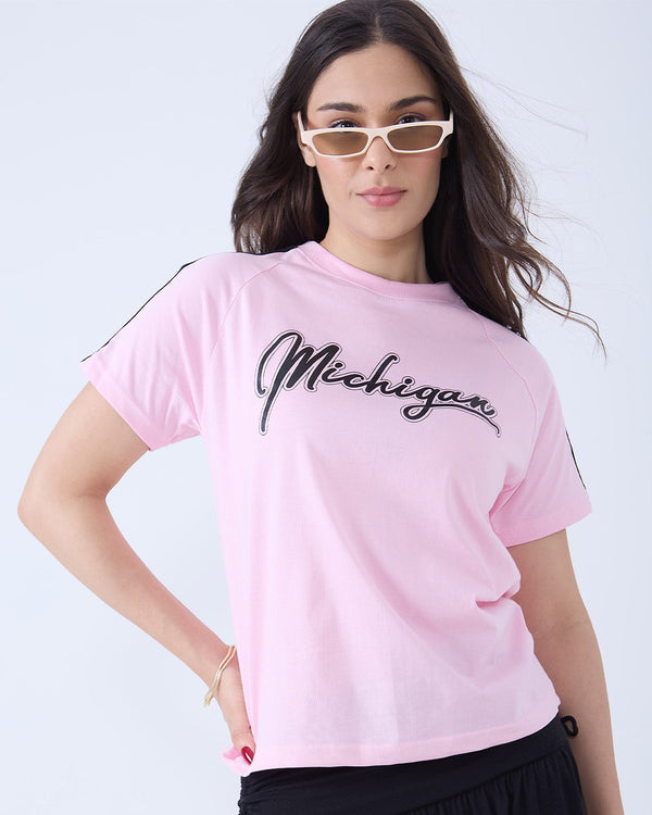 Michigan Curve T-Shirt – pink regular tee with Michigan script graphic, worn by model.