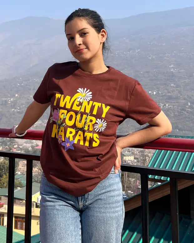 mountains in the background with a woman posing in a brown printed tshirt