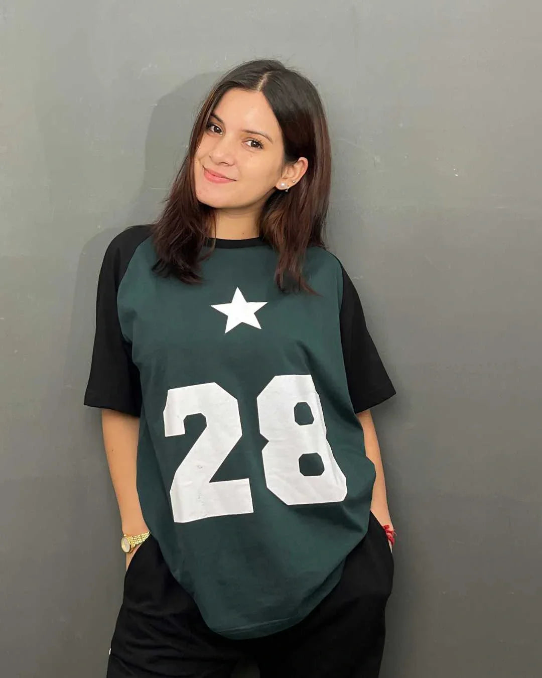 28 Raglan Oversized T-Shirt – dark green body with black raglan sleeves, white star and 28 graphic, worn by model