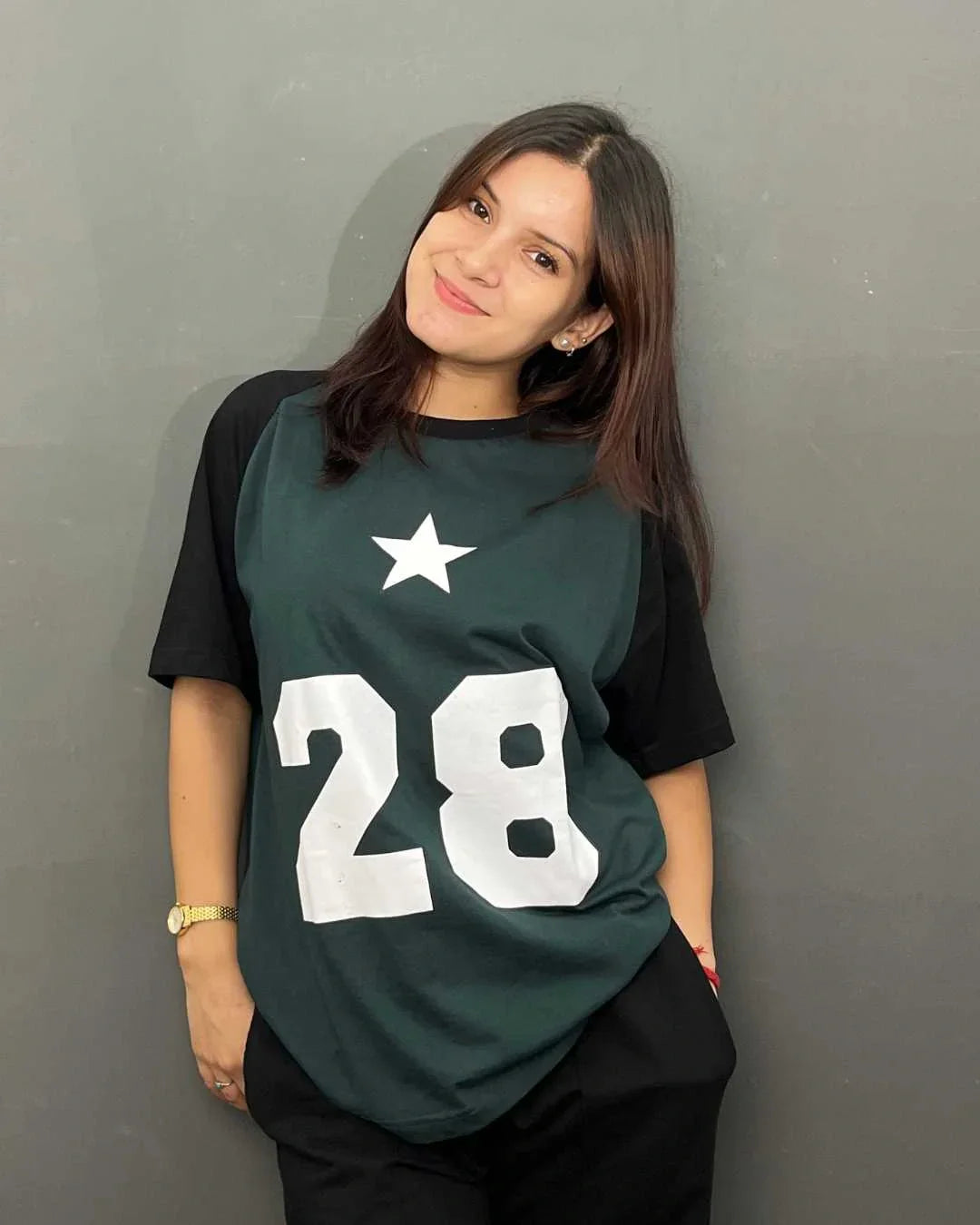 DKY 28 Raglan Oversized T-Shirt – dark green body with black sleeves, bold white 28 and star graphic, worn by model