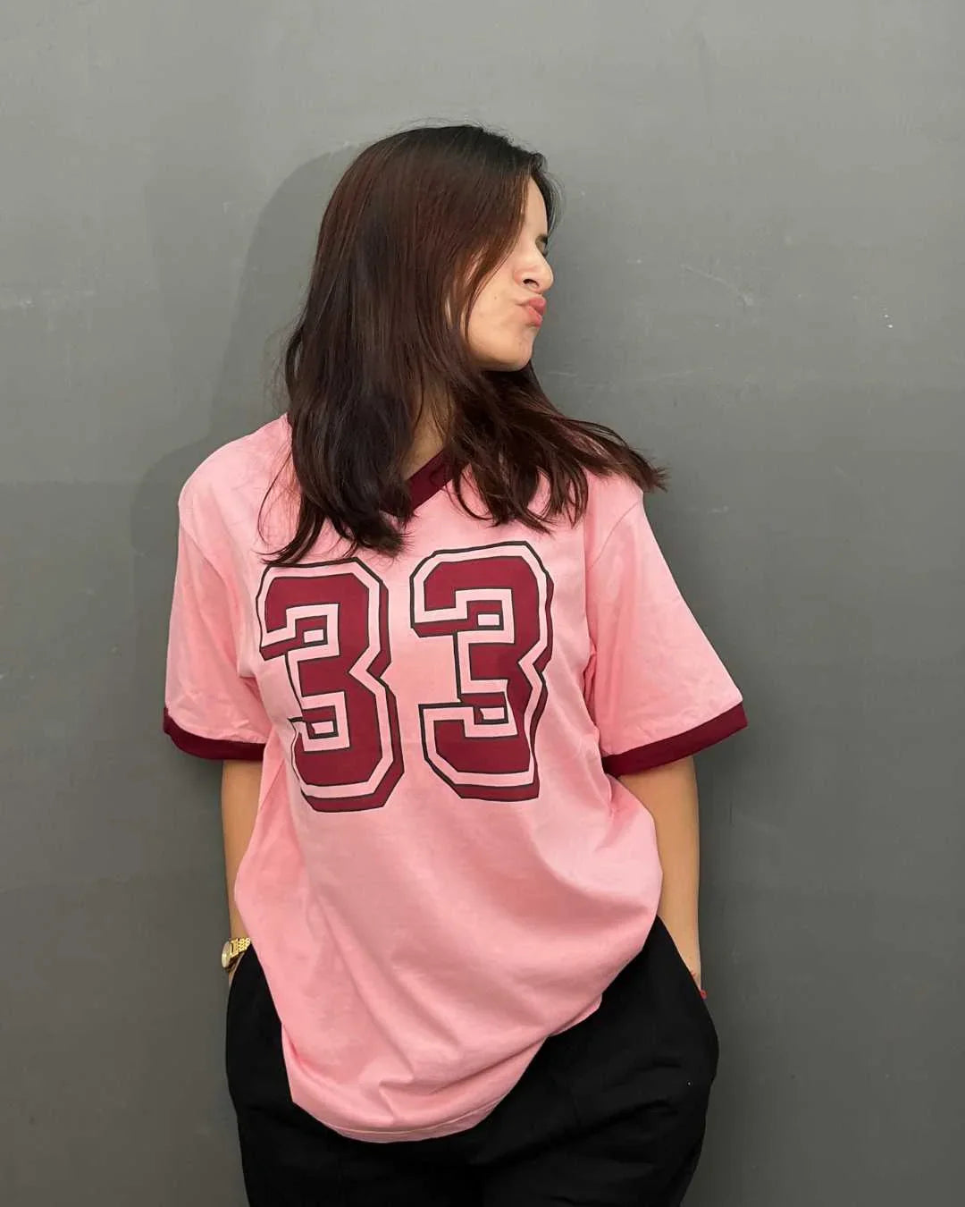 33 Tap-Out V-Neck Oversize T-Shirt – pink DKY oversized tee with a large burgundy 33 graphic, worn by model