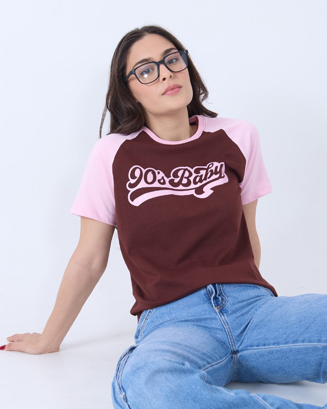 90's Baby Raglan T-Shirt – burgundy body with pink sleeves, relaxed fit, graphic 90's Baby on chest worn by model