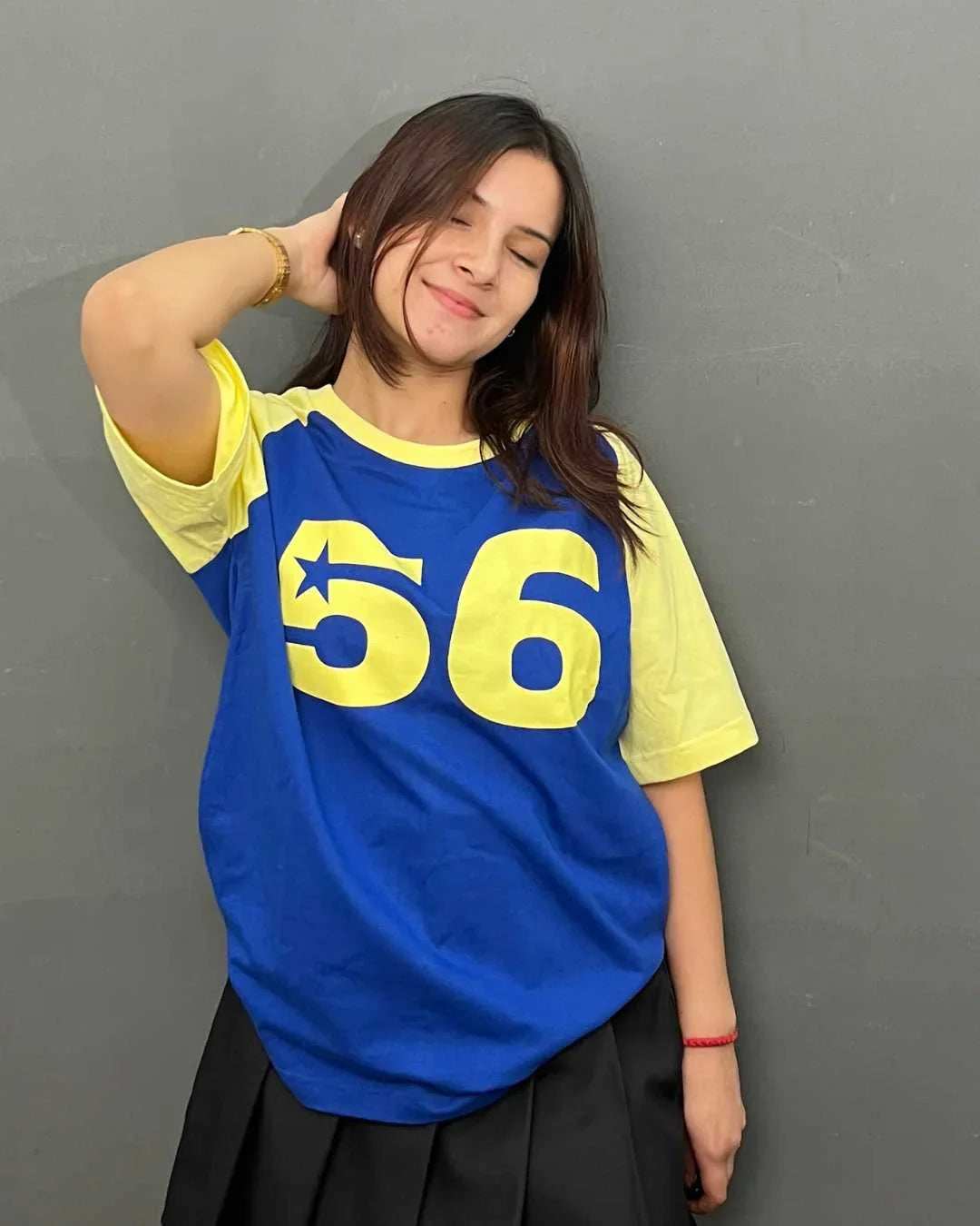 56 Raglan Oversized T-Shirt - blue body with yellow sleeves and large 56 graphic with star, worn by model.