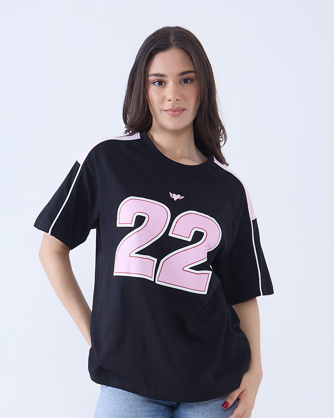 22 Downtown Oversized T-Shirt – black tee with pink 22 graphic and pink shoulder stripes, worn by model