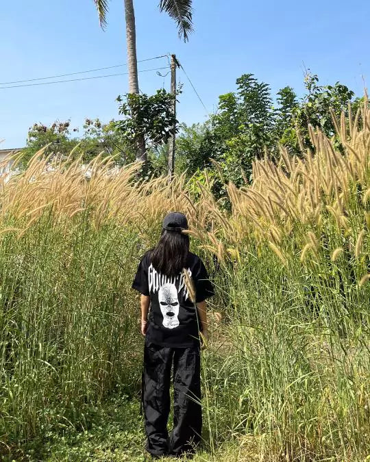 Arlo Black Gangster Oversized T-Shirt - black cotton tee with graphic back print, worn by a person in a field