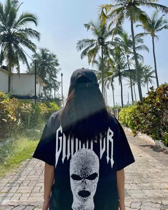 Arlo Black Gangster Oversized T-Shirt worn by a model outdoors, white gangster text and masked graphic