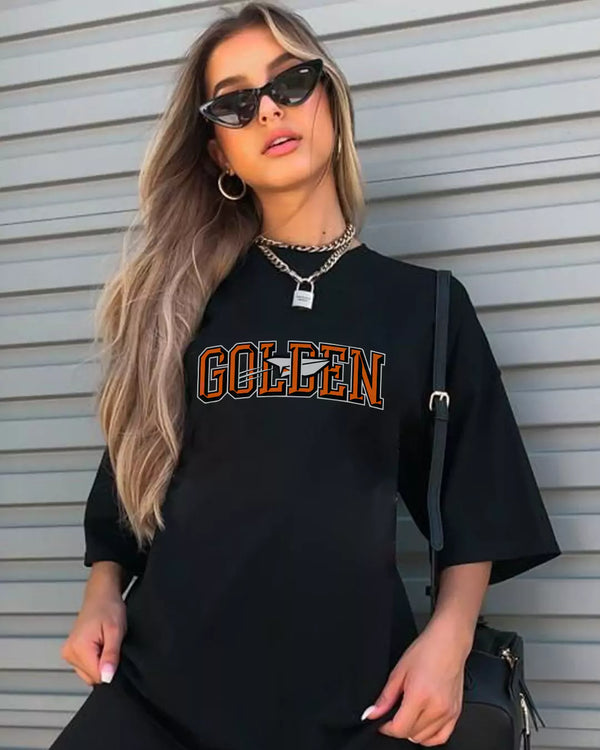 Arlo Golden Oversized T-Shirt – black oversized tee with orange-outlined GOLDEN graphic, worn by model