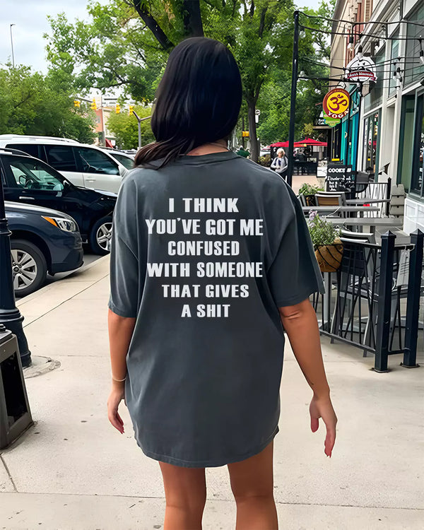 Arlo IDK Oversized T-Shirt, charcoal gray, oversized fit, with bold white slogan text on back, worn by model.