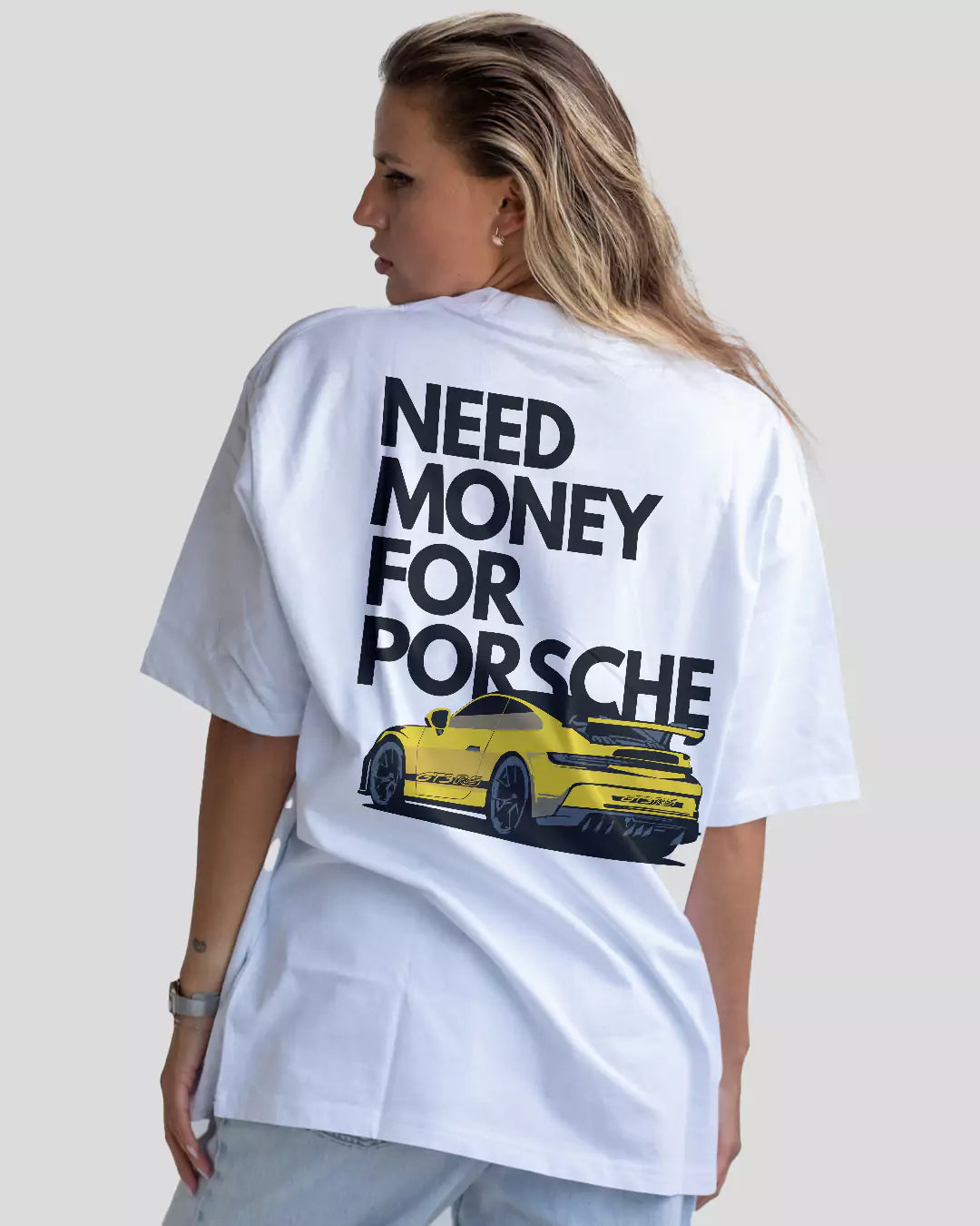 Arlo Need Money For Porsche Oversized T-Shirt white graphic tee with black text and yellow Porsche, worn by model