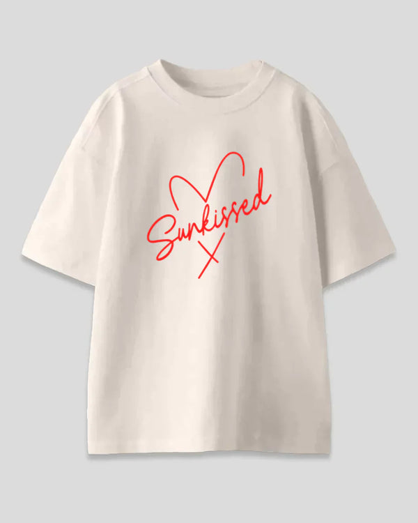 Arlo Sunkissed Oversized T-Shirt – cream cotton tee with bold red Sunkissed script graphic, shown in flat lay