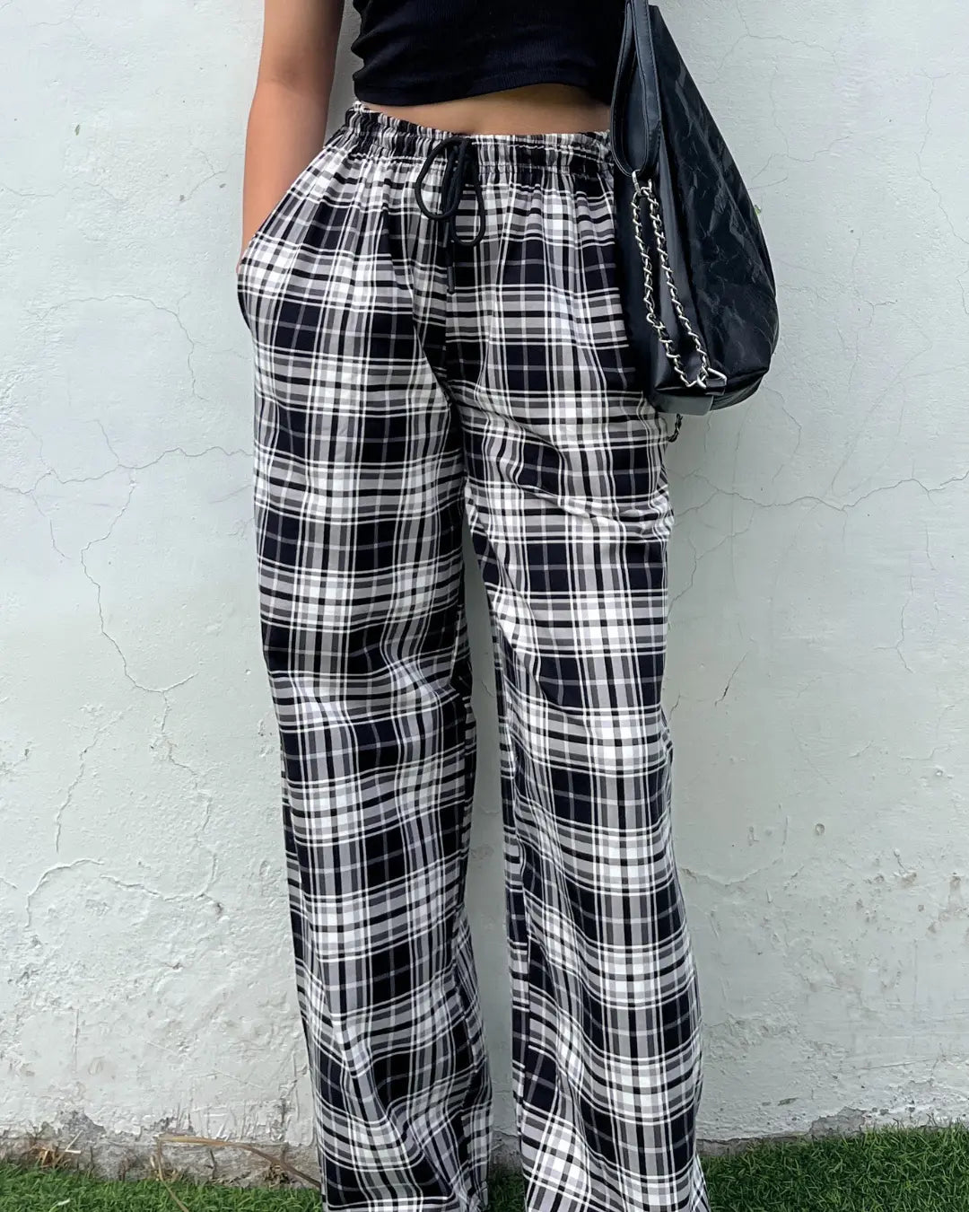 Black Checkered Pajama Pants by DKY, black and white plaid with a drawstring waist, worn by model.