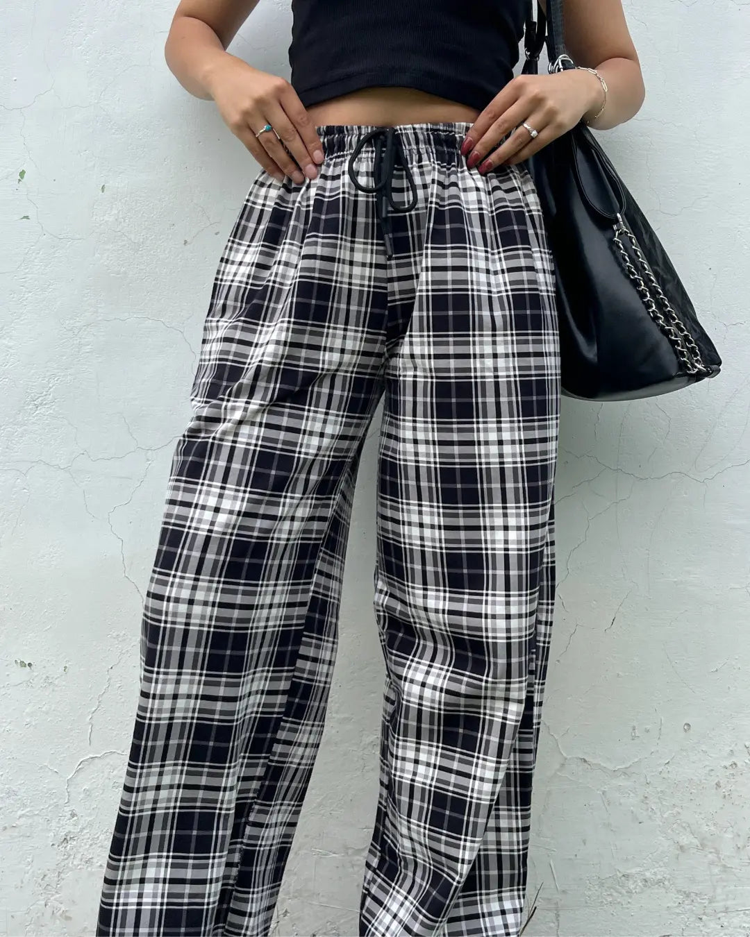 Black Checkered Pajama pants by DKY – black and white plaid, relaxed fit with drawstring, worn by model