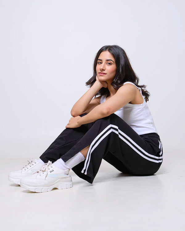 Black Gossip Pants - black joggers with white side stripes, worn by model