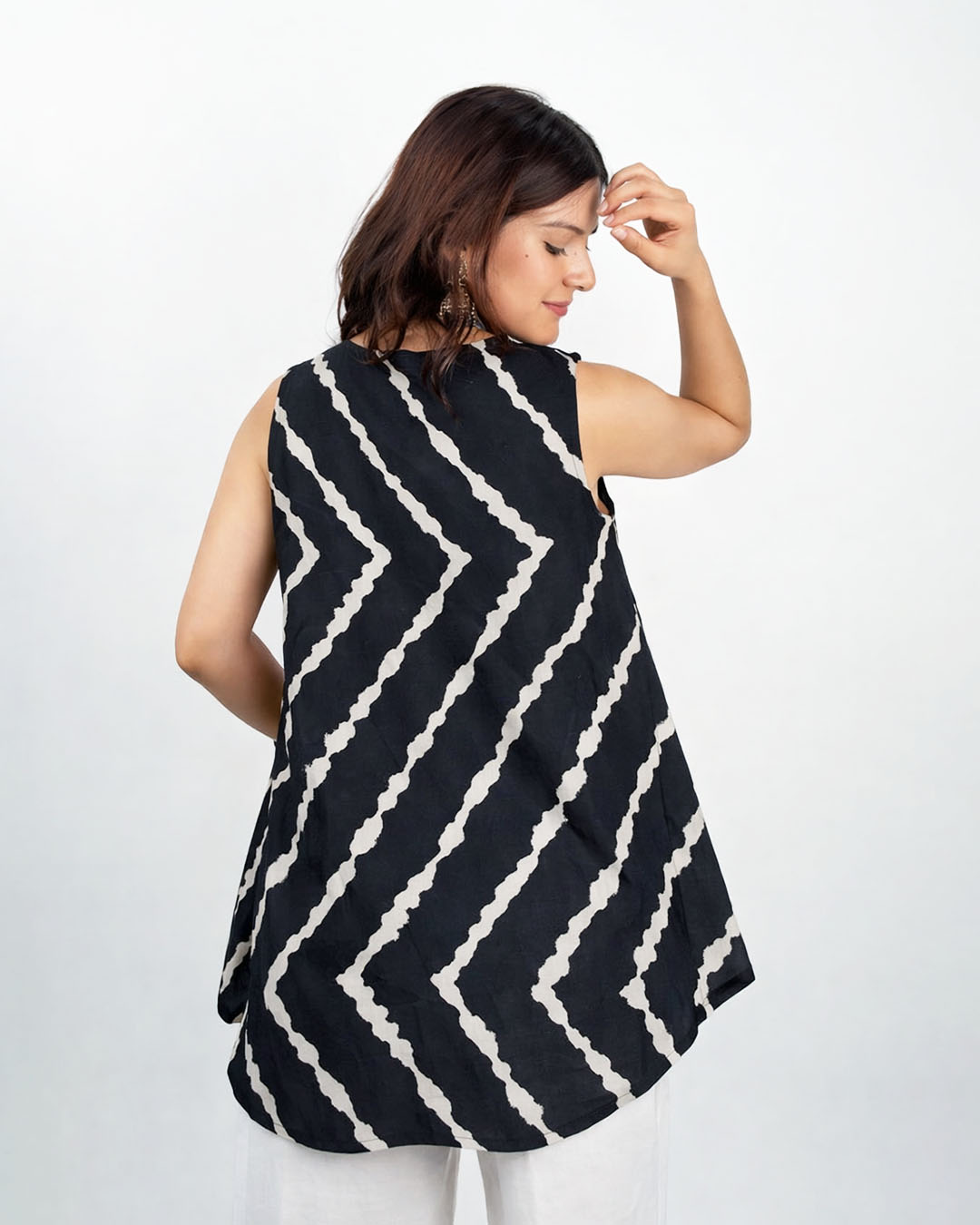 Black Leheriya High Low Kurti - with white printed leheriya pattern, sleeveless with high-low hem, worn by model